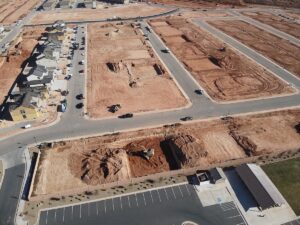Excavator trenching at a residential development site in Southern Utah